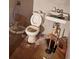 Bathroom with old toilet, sink, and damaged floor at 3448 Orchard Cir, Decatur, GA 30032