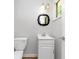Bathroom featuring a white single sink vanity with an ornate framed mirror at 3900 Bressler Cir, Decatur, GA 30035