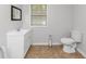 Bathroom featuring a white single sink vanity with toilet and tile flooring at 3900 Bressler Cir, Decatur, GA 30035