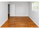 Comfortable bedroom featuring hardwood floors, a window with blinds, and closet access at 3900 Bressler Cir, Decatur, GA 30035