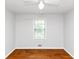 Cozy bedroom featuring hardwood floors, a neutral color palette, and plenty of natural light at 3900 Bressler Cir, Decatur, GA 30035
