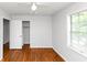 Comfortable bedroom with hardwood floors, a window with blinds, and a spacious closet at 3900 Bressler Cir, Decatur, GA 30035