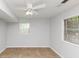 Bedroom with neutral walls, tile flooring, ceiling fan, and natural light from windows at 3900 Bressler Cir, Decatur, GA 30035