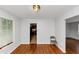 Dining area features hardwood floors, neutral walls, and a view to the kitchen at 3900 Bressler Cir, Decatur, GA 30035