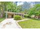 Two-story home boasts mature trees, grass lawn and convenient covered parking at 3900 Bressler Cir, Decatur, GA 30035