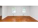 Large living room with hardwood floors and plenty of natural light from two windows at 3900 Bressler Cir, Decatur, GA 30035