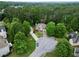 Aerial view of a brick home with lush greenery and a long driveway at 4325 Camellia Ridge Sw Way, Lilburn, GA 30047