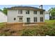 The backyard features a patio and lush greenery behind the home at 4325 Camellia Ridge Sw Way, Lilburn, GA 30047
