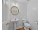 Powder room with pedestal sink, toilet and gold framed mirror at 4325 Camellia Ridge Sw Way, Lilburn, GA 30047