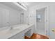 Well-lit bathroom featuring double sinks and a large mirror over a white vanity at 4325 Camellia Ridge Sw Way, Lilburn, GA 30047