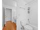 Clean bathroom with a toilet, shower/tub combo, and wood floors at 4325 Camellia Ridge Sw Way, Lilburn, GA 30047