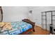 Cozy bedroom featuring wood floors, a wooden bed frame, and an abundance of natural light at 4325 Camellia Ridge Sw Way, Lilburn, GA 30047
