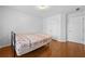 Sunlit bedroom with wood floors, a closet, and a comfortable bed frame at 4325 Camellia Ridge Sw Way, Lilburn, GA 30047