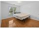 Bright bedroom boasts wood floors and a window with views of the outdoors at 4325 Camellia Ridge Sw Way, Lilburn, GA 30047
