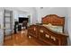 Bedroom featuring hardwood floors, natural light, and wood furniture at 4325 Camellia Ridge Sw Way, Lilburn, GA 30047