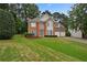Beautiful two-story brick home with well-maintained lawn and double garage at 4325 Camellia Ridge Sw Way, Lilburn, GA 30047