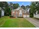 Traditional brick home with two-car garage and manicured lawn at 4325 Camellia Ridge Sw Way, Lilburn, GA 30047