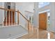 Bright foyer with wooden staircase, light tile flooring, and large windows at 4325 Camellia Ridge Sw Way, Lilburn, GA 30047