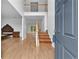 Open foyer with high ceilings, wooden staircase, and neutral tile flooring at 4325 Camellia Ridge Sw Way, Lilburn, GA 30047
