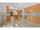 Well-lit modern kitchen featuring stainless appliances, a center island, and wood cabinets at 4325 Camellia Ridge Sw Way, Lilburn, GA 30047