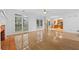 Bright living room adjacent to the kitchen features hardwood floors and large windows at 4325 Camellia Ridge Sw Way, Lilburn, GA 30047