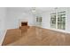Bright living room features hardwood floors, fireplace, and multiple windows for natural light at 4325 Camellia Ridge Sw Way, Lilburn, GA 30047