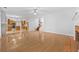 Open-concept living area with gleaming hardwood floors flowing into the modern kitchen at 4325 Camellia Ridge Sw Way, Lilburn, GA 30047