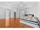 Spacious main bedroom with hardwood flooring, ceiling fan, and tray ceiling at 4325 Camellia Ridge Sw Way, Lilburn, GA 30047