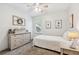 Cozy bedroom featuring neutral tones, a ceiling fan, and a dresser with decor at 4915 Bayberry Dr, Cumming, GA 30040