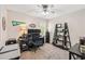 Functional bedroom with a ceiling fan, desk setup, and shelving at 4915 Bayberry Dr, Cumming, GA 30040