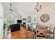 Cozy dining area with vaulted ceiling adjacent to a fireplace and living room at 4915 Bayberry Dr, Cumming, GA 30040