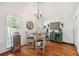 Charming dining area with wood floors, chandelier and a bright window at 4915 Bayberry Dr, Cumming, GA 30040