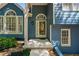 Inviting front entrance with decorative glass door, sidelight window and blue siding at 4915 Bayberry Dr, Cumming, GA 30040