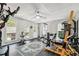 Bright home gym featuring modern exercise equipment, rubber flooring and natural light from large windows at 4915 Bayberry Dr, Cumming, GA 30040