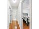 Hallway leading to bedroom with hardwood floors and natural light at 4915 Bayberry Dr, Cumming, GA 30040