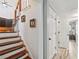 Hallway featuring hardwood stairs and a baby gate with adjacent closet doors at 4915 Bayberry Dr, Cumming, GA 30040