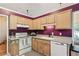 Cozy kitchen with wooden cabinets and modern white appliances at 4915 Bayberry Dr, Cumming, GA 30040