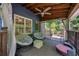 Relaxing screened porch with a ceiling fan, comfortable seating, and views of the lush backyard at 4915 Bayberry Dr, Cumming, GA 30040