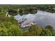 A picturesque lake view showcasing a dock with several boats, surrounded by lush trees at 5065 Harbour Ridge Dr, Alpharetta, GA 30005