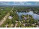 An aerial view of the lake, homes, and pool surrounded by dense trees at 5065 Harbour Ridge Dr, Alpharetta, GA 30005
