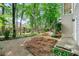 Landscaped backyard featuring a gravel area, wood fencing, and wood stairs that lead up to a deck at 5065 Harbour Ridge Dr, Alpharetta, GA 30005