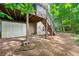 Backyard featuring a deck with stairs, exterior storage, and a landscaped area with natural surroundings at 5065 Harbour Ridge Dr, Alpharetta, GA 30005