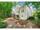 Two-story home showcasing a backyard with lush greenery and an elevated deck with stairs to ground level at 5065 Harbour Ridge Dr, Alpharetta, GA 30005