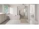 Bright bathroom with an all-white design that features a soaking tub, glass shower, and tile floors at 5065 Harbour Ridge Dr, Alpharetta, GA 30005