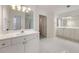 Bright bathroom featuring a double sink vanity and a large mirror above with modern lighting at 5065 Harbour Ridge Dr, Alpharetta, GA 30005