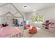 Bedroom features a play area, bright windows, a pink play kitchen, and cozy beanbag chairs at 5065 Harbour Ridge Dr, Alpharetta, GA 30005