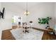 Bright dining room with hardwood floors and natural light, featuring modern lighting and neutral decor at 5065 Harbour Ridge Dr, Alpharetta, GA 30005