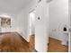 Hallway with hardwood floors leads to a half bathroom and a bookcase at 5065 Harbour Ridge Dr, Alpharetta, GA 30005