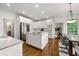Open kitchen features stainless appliances, a center island with cooktop, and a dining area at 5065 Harbour Ridge Dr, Alpharetta, GA 30005