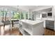 Island kitchen with seating and stainless steel appliances and dining area with natural light at 5065 Harbour Ridge Dr, Alpharetta, GA 30005